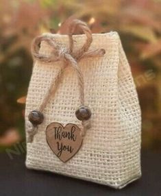 a small bag with a wooden heart on the front and thank you written on it