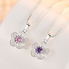 Add some playful charm with this Cute Cherry Blossom Necklace featuring a dainty design and a choice between a pink or purple gem. Its beauty and uniqueness will have you feeling stunning and blooming with confidence. (Plus, it's so cute you'll want to wear it every day!) 🌸Description: Product Type: Necklace Modeling: Flower Product Material: S925 + High Quality Zircon Product Size: Pendant height is about 17mm. Width is about 12mm. Color: 925 sterling silver pink water-containing glass chain. Cherry Blossom Necklace, Cherry Necklace, Purple Gems, Peach Blossom, Purple Necklace, Women's Jewelry Sets, Pendent Necklace, Peach Blossoms, Floral Necklace