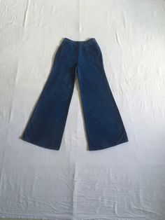 "1970s high waist bell bottom blue jeans cotton zip fly  button snap 2 front pockets authentic age wear aged patina w/fade streaks red, white, blue stitching label size 13/14 (much smaller, see below) measures, lying flat, waist- 13\" to 13 1/2\" with a tug  rise-12\" inseam-31\" hem-13\" hip-21\" total length-42\"     We do not offer returns or refunds unless something is grossly misrepresented. Please contact us within 2 business days of receiving to discuss any possible returns for this reason. We do not offer refunds for your shipping fees. Please feel free to contact us with any questions you may have about an item prior to purchase and we will gladly answer them." Vintage Washed Blue Bottoms For Fall, Vintage Wide Leg Pants For Fall, Retro High Waist Cotton Flare Jeans, Retro Wide Leg Washed Blue Bottoms, Retro High Rise Denim Blue Flares, Denim Blue Cotton Straight Leg Flares, Vintage Dark Wash Pants For Fall, Dark Wash Full Length Cotton Flares, Full-length Dark Wash Cotton Flares