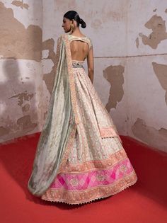 This stunning bandhani banarasi lehenga features a striking jamawar panel that adds depth and richness. The embroidered blouse showcases a scalloped neckline and exquisite cutwork detail on the hem. Paired with a sheer pista dupatta adorned with floral butis and delicate gota, this ensemble radiates elegance. The waist belt, embellished with mirrors, enhances the look with a touch of sparkle, making it perfect for any festive occasion. Green Brocade Lehenga With Cutdana, Green Bollywood Lehenga With Bandhani Print, Bollywood Style Green Lehenga With Bandhani Print, Green Brocade Anarkali Set With Dupatta, Semi-stitched Green Lehenga With Bandhani Print, Green Semi-stitched Lehenga With Bandhani Print, Green Raw Silk Lehenga With Meenakari, Green Meenakari Raw Silk Lehenga, Green Semi-stitched Bandhani Print Lehenga