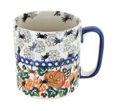 a blue and white mug with halloween decorations on it