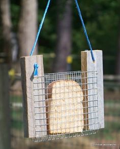 a bird feeder with bread hanging from it's side