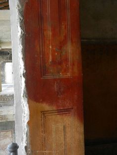 an old door is painted red and yellow