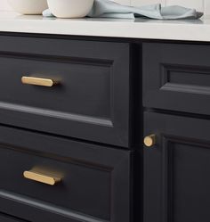 a white bowl sitting on top of a black dresser