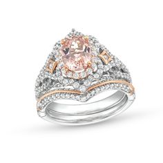 an engagement ring set with a pink diamond in the center and two white diamonds on each band