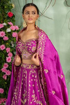 Purple lehenga with zardozi hand embroidery in floral, Mughal motifs and scallop pleated hem. Paired with an off-shoulder blouse and an embroidered dupatta.
Component: 3
Pattern: Embroidered
Type Of Work: Zardozi work
Neckline: Off-shoulder
Sleeve Type: Full sleeves
Fabric: Silk, Satin organza
Color: Purple
Other Details: 
Scallop pleated lehenga hem
V-back blouse
Closure:
Blouse: Back concealed hooks
Occasion: Wedding, Reception - Aza Fashions Off Shoulder Lehenga, Mughal Motifs, Pleated Lehenga, Purple Lehenga, Shoulder Off, Zardozi Work, Embroidered Dupatta, Purple Silk, Fabric Silk