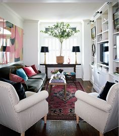 a living room filled with furniture and a rug