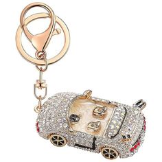 a car shaped key chain with lots of crystals on it's front and back