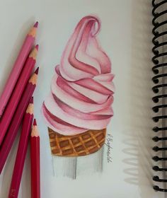 colored pencils next to a drawing of an ice cream cone with pink icing