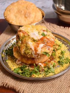 a plate with some food on top of it next to a pie and other dishes