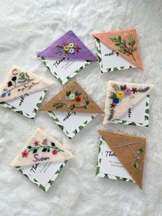 six handmade cards with flowers on them are laid out on a white furnishing