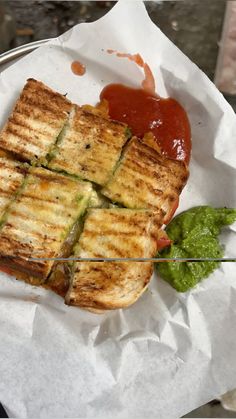 a grilled sandwich sitting on top of a white paper