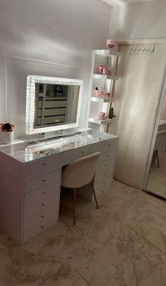 a white desk topped with a mirror and drawers