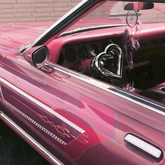 the interior of a pink convertible car is shown