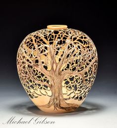 a gold vase with a tree on it