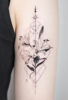 a black and white photo of a flower tattoo on the right arm, with geometric shapes in the background