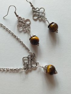 Tiger's eye Silver jewelry set earrings and necklace Victorian jewelry set Boho jewelry set tiger eye jewelry long earrings brown earrings Tiger's eye Victorian jewelry set necklace and earrings . Bohemian jewelry set necklace and earrings . Beautiful silver-tone Antique style Tiger eye set necklace and earrings . Silver-tone filigree set earrings and  pendant necklace . Victorian style earrings and necklace . Boho earrings and necklace. Romantic jewelry set earrings and necklace. Beautiful earr Metal Jewelry Sets With Matching Dangle Earrings, Metal Dangle Jewelry Set With Matching Earrings, Elegant Brown Metal Jewelry, Elegant Handmade Brown Jewelry, Elegant Brown Jewelry Gift, Brown Sterling Silver Jewelry For Gifts, Elegant Brown Jewelry For Gift, Elegant Copper Jewelry With Natural Stones, Elegant Brown Round Jewelry