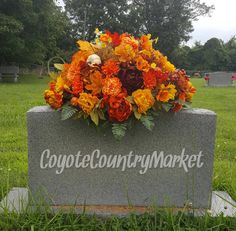 an arrangement of flowers is placed on the grave