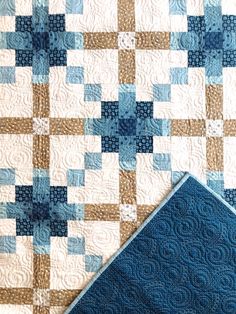 two blue and white quilts on top of each other