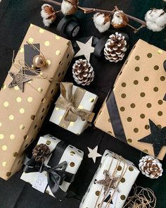 presents wrapped in brown paper and decorated with gold polka dots, pine cones, twine bows and star decorations