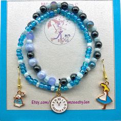 Our Alice In Wonderland Jewelry Set is for all the curious girls out there or maybe the ones who are late for a very important date! The stretch bracelet duo is made with .5 double strung elastic.  It features a combination of light blue glass and seed beads mixed with Hematite beads. The second bracelet is a combination of two tone blue glass seed beads.  The two bracelets are joined together with a jump ring and a white enamel and gold plated pocket watch charm.  To finish out our Alice in Wonderland set is a pair of our signature mismatched earrings.  In order to honor our theme we went with an Alice charm and a White Rabbit charm.   We know any of you that love this story will truly enjoy this set! Whimsical Beaded Bracelets, Whimsical Blue Jewelry With Charms, Alice And Wonderland Accessories, Alice In Wonderland Jewelry Diy, Mad Hatter Costume Accessories, Cheshire Cat Jewelry, Alice In Wonderland Bracelet, Disney Multicolor Jewelry Gift, Alice In Wonderland Jewelry