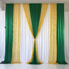 green and gold drapes are hanging on the wall in front of a white backdrop