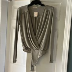 Beautiful Silver Sheen Soft Polyester, Intimately Free People Body Suit. Size Small. Never Worn. Elegant Bodysuit For Spring Loungewear, Elegant Spring Bodysuit For Loungewear, Elegant Spring Loungewear Bodysuit, Free People Dolly Bodysuit, Free People Lace Body Suit, Metallic Fitted Long Sleeve Bodysuit, Metallic Long-sleeve Bodysuit For Party, Free People Clean Lines Long Sleeve, Girls Corset