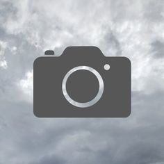 a camera with clouds in the background