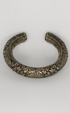 This hollow silver chased bracelet is from China and was made sometime in the mid 20th century. 7 inches inside circumference including gap, which is about 1.5 inches. The inside width is approximately 2.5 inches. This chased bracelet is hollow, with grains of sand inside, and weighs approximately 48 grams. Antique Silver Hand Cast Bracelets, Antique Silver Etched Cuff Bangle, Antique Silver Hand-cast Bracelets, Silver Carved Bracelet For Ceremonial, Silver Carved Bracelet, Carved Silver Bangle For Formal Occasions, Silver Carved Bangle For Formal Occasions, Silver Etched Round Bracelets, Carved Silver Bracelet