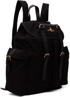 Canvas backpack in black. · Grained leather trim throughout · Carry handle at top · Adjustable padded shoulder straps · Logo hardware at face · Flap pockets at sides · Pin-buckle straps at foldover flap · Concealed drawstring closure · Zip pocket at interior · Twill lining · Logo-engraved antiqued gold-tone hardware · H16 x W19 x D4.5 Part of the Made in Kenya collection in collaboration with ITC Ethical Fashion Initiative. Supplier color: Black Classic Backpack With Gold-tone Hardware For Travel, Classic Travel Backpack With Gold-tone Hardware, Classic Black Backpack With Gold-tone Hardware, Black Leather Backpack With Gold-tone Hardware For Travel, Black Backpack With Gold-tone Hardware, Designer Black Backpack With Leather Trim, Classic Black Backpack With Leather Handles, Travel Backpack With Buckle Closure, Luxury School Backpack With Leather Trim