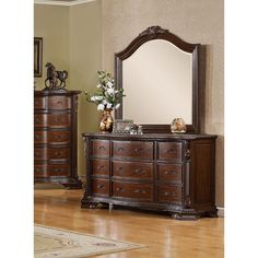 a large mirror sitting on top of a wooden dresser