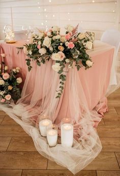 a table with candles and flowers on it