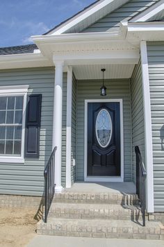 a house with a black door and white pillars