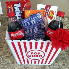 a popcorn box filled with soda and snacks