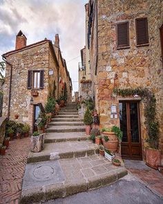 an old stone building with steps leading up to the front door and windows on each side