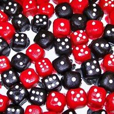 red and black dices with white polka dots on them are shown in close up