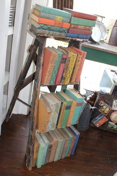 an old wooden book stand with many books on it