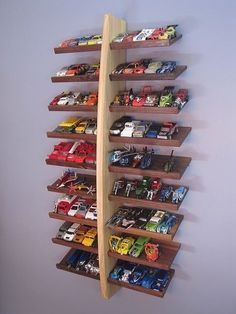 a wooden shelf with toy cars on it