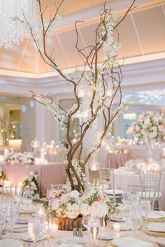 the centerpieces are decorated with flowers and branches