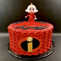 a red cake with a small figure on top