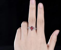 Introducing our Vintage Pear Red Ruby Engagement Ring set, a masterpiece inspired by the allure of nature's intricate beauty. This unique cluster diamond bridal wedding ring set seamlessly blends vintage charm with modern elegance. Ring set comes with the engagement ring and band. By default, the accent stones are set with moissanite accents from VS to VSS clarity. Please contact us if you would like to have this changed to lab grown or natural diamonds. Product Details Pear Red Ruby: The heart Feminine Softness, Bridal Wedding Rings, Ruby Engagement Ring, All Gems, Wedding Ring Set, Solid Gold Jewelry, Small Rings, Ring Metal, Ruby Diamond