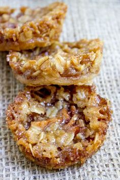 three cookies are stacked on top of each other with nuts in the middle and oatmeal toppings