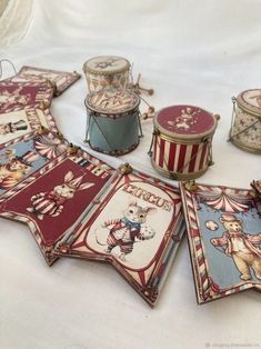 an assortment of circus themed items on a white tablecloth with red and blue stripes