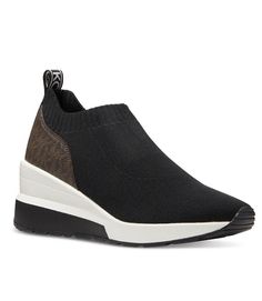 Get ready to step up your fashion game with these Michael Kors Mabel Slip-On Trainer Sneakers. These sneakers come in classic black color and are perfect for casual occasions. The shoes are designed with a low-top shaft style and slip-on closure, making them easy to wear and comfortable for walking. The sneakers are made of fabric and manmade upper material with a rubber outsole for durability. They are lightweight and feature a comfortable design. These Michael Kors sneakers are perfect for modern women who love to stay on trend. Casual Black Slip-on Sneakers With Contrast Sole, Sporty Black Slip-on Sneakers For Walking, Casual Black Slip-on Sneakers With Textured Sole, Black Slip-on Sneakers With Rubber Sole For Walking, Sporty Slip-on Wedge Sneakers For Streetwear, Modern Slip-on Sneakers With Boost Midsole, Black Slip-on Tpr Sneakers, Black Tpr Slip-on Sneakers, Slip-on Boost Midsole Low-top Sneakers