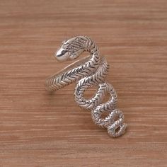 With nearly 400 individual muscles and as many ribs snakes glide effortlessly along any terrain. The unique shape they take during movement is captured in breathtaking detail in this sterling silver ring. Crafted by Balinese artisan Suar Dwipayana the asp's scaly body is depicted using a hand-engraved process with the pattern continuing throughout the ring's crown and band. Snake Ring Silver, Silver Cocktail, Snake Ring, Sterling Silver Dangle Earrings, Unique Jewelry Designs, Pearl Earrings Dangle, Silver Pieces, Balinese, Silver Earrings Dangle