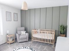 a baby's room with a crib, chair and rug