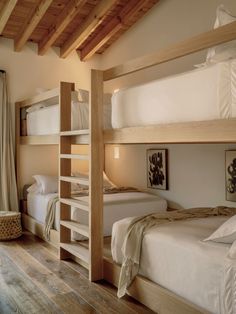 bunk beds in a room with wooden floors and walls