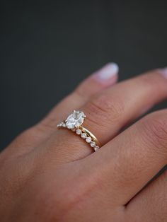 a woman's hand with a diamond ring on it