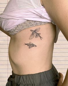 a woman's stomach with two birds on it