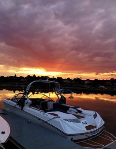 a boat is docked in the water at sunset